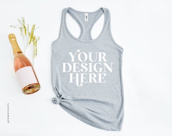 May include: A gray racerback tank top with the text "YOUR DESIGN HERE" printed in white on the front. The tank top is lying flat on a white surface.