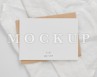 May include: A white card mockup with the text "MOCKUP" and "7 x 5" inches, "jpg + psd" on a white linen background.