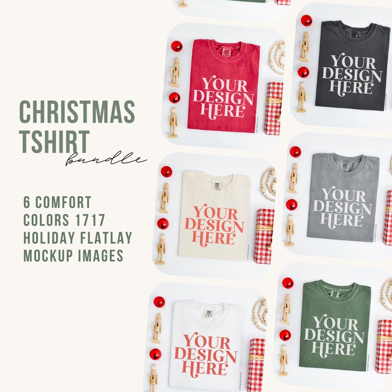 May include: A flatlay mockup of six different colored t-shirts with the text "YOUR DESIGN HERE" printed on each. The t-shirts are arranged on a white surface with red ornaments, wooden nutcrackers, and a red and white checkered gift box.