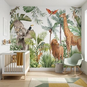 May include: A nursery room featuring a large wall mural of a jungle scene with a gray elephant, a tall giraffe, a lion, a toucan, a parrot, and a monkey amidst green palm leaves. A white wooden crib with a yellow blanket and a light green rocking chair.