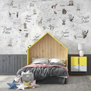 Puede incluir: Un mural de pared que muestra un mapa del mundo con ilustraciones de varios animales y globos aerost&aacute;ticos. El mapa incluye etiquetas de continentes y oc&eacute;anos. Una estructura de cama en forma de casa con cabecero de madera se sit&uacute;a delante.