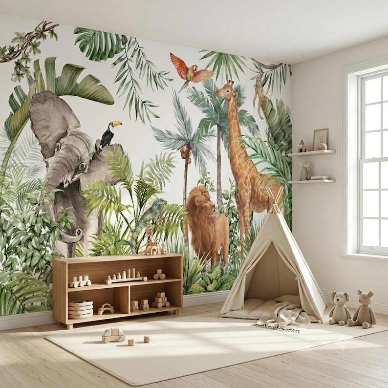 May include: A wall mural featuring a watercolor jungle scene with an elephant, giraffe, lion, toucan, parrot, and monkey amidst green palm leaves. A wooden bookshelf with toys and a beige fabric play tent are positioned in front of the wall.