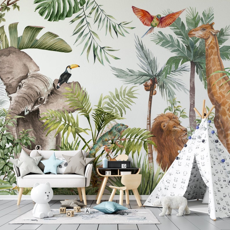 May include: A white sofa with star-shaped pillows, a small wooden desk and chair, and a white play tent featuring a black animal print. The wall behind displays a large watercolor mural of a jungle scene with an elephant, lion, giraffe, and toucan.