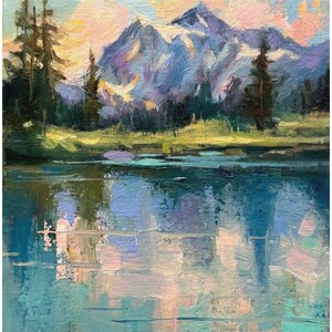 May include: An oil painting depicting a mountain landscape with a lake. The artwork shows a lake reflecting the sky and mountains, with trees on the left and a mountain range in the background. The colour palette includes blues, greens, and pinks.