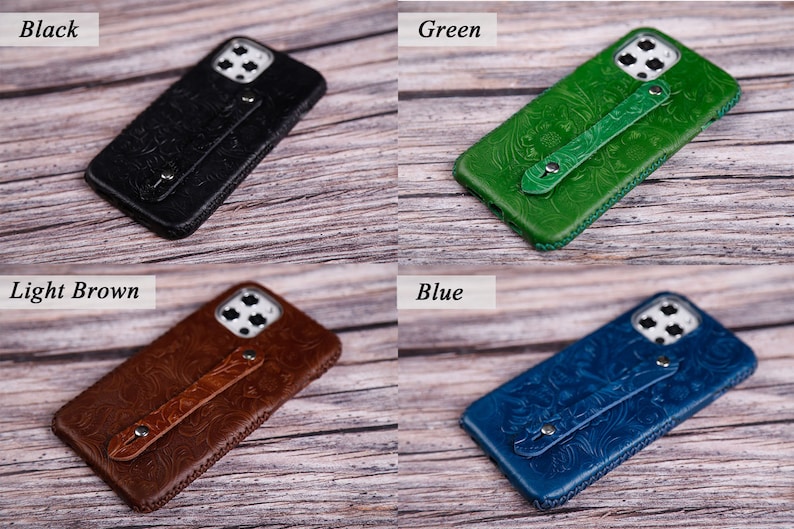 May include: Four leather phone cases in black, green, light brown, and blue. Each case features a floral embossed design and a hand strap. The cases are displayed on a wooden surface.