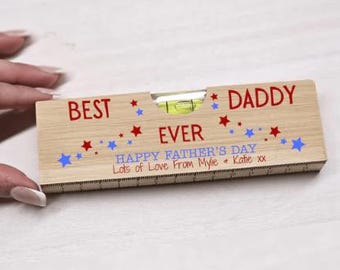 May include: Wooden level tool with a red and blue star design. The level reads "Best Daddy Ever" and "Happy Father's Day. Lots of Love from Mylie & Katie xx".