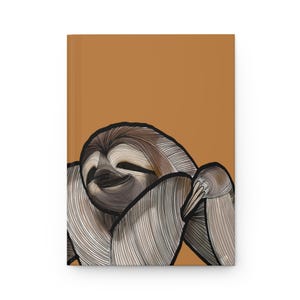 May include: A hardcover notebook featuring a stylized illustration of a sloth on a solid tan background. The sloth is rendered with fine black line work, showcasing its face and limbs in shades of brown, beige, and cream with a thick black outline.