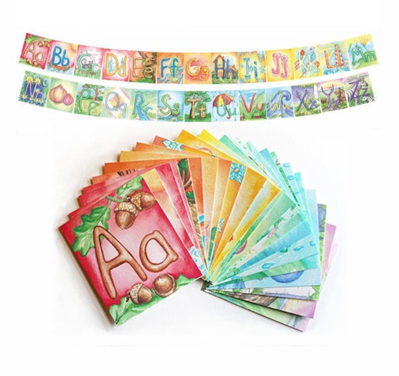 May include: A set of alphabet flash cards with colorful illustrations. Each card features a letter of the alphabet with a corresponding image. The cards are arranged in a rainbow pattern.