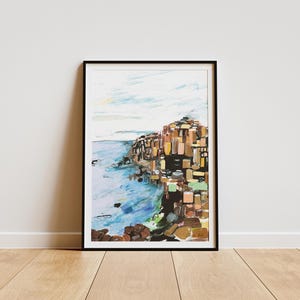 May include: A colorful abstract painting of a rocky cliffside with a blue ocean in the foreground. The painting is framed in black.
