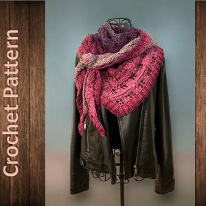 May include: A crocheted shawl in shades of purple and pink, draped over a black leather jacket on a mannequin.