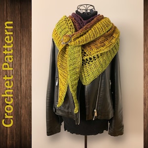 May include: A green, yellow, and purple crocheted shawl with a decorative buckle. The shawl is draped over a black leather jacket.