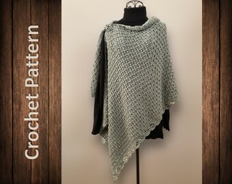 May include: A light green crochet shawl with a lacy edge. The shawl is draped over a black mock neck shirt on a mannequin.
