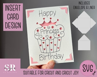 May include: A pink and white cupcake with a crown and the text "Happy Princess Birthday" on a white card with pink corners. The card includes a matching envelope and liner.
