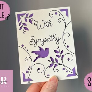 May include: A white card with a purple bird and floral design. The card says "With Sympathy".