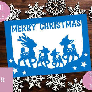 May include: Blue card with the text "Merry Christmas" and a silhouette of four reindeer. The reindeer are in a line, with the largest reindeer in the front and the smallest reindeer in the back. The card is decorated with white stars.