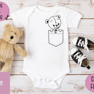 May include: White baby onesie with a black outline of a teddy bear peeking out of a pocket.