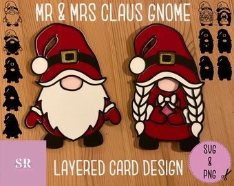 May include: Layered card design featuring a red and white gnome couple with white braids. The design includes the text "Mr & Mrs Claus Gnome" and "Layered Card Design".