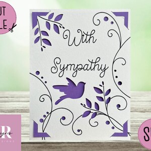 May include: A white card with a purple bird and floral design. The card says "With Sympathy" in black cursive writing.