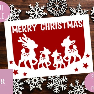 May include: A red card with the text "Merry Christmas" in white. The card has a white silhouette of a family of four reindeer with white stars around them.