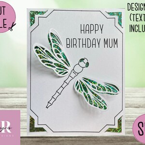 May include: A white card with a black border and a green dragonfly cut out. The card says "Happy Birthday Mum".