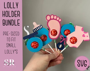 May include: A set of five baby-themed lollipop holders, each featuring a different design: a baby bottle, a footprint, a rattle, a onesie, and a stroller. The holders are made of colorful cardstock and are pre-sized to fit small lollipops. The image includes the text "LOLLY HOLDER BUNDLE" and "PRE-SIZED TO FIT SMALL LOLLY'S".