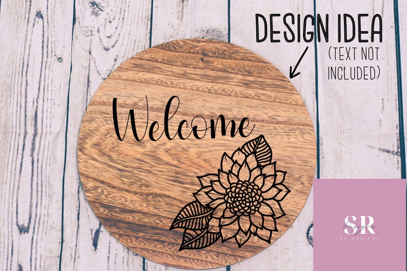 May include: A round wooden sign with the word "Welcome" in black cursive lettering and a black floral design in the lower right corner.