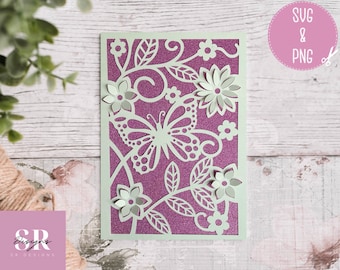 May include: A white card with a purple glitter background and a white butterfly and floral design. The card is cut out to create a delicate, intricate design.