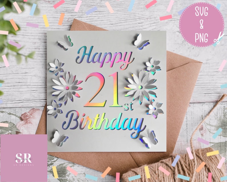 May include: A white card with a holographic iridescent design. The card says "Happy 21st Birthday" with flowers and butterflies surrounding the text.