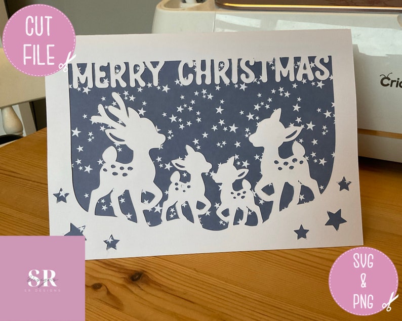 May include: A white card with a blue background and a white silhouette of a family of deer with the text "Merry Christmas" at the top.