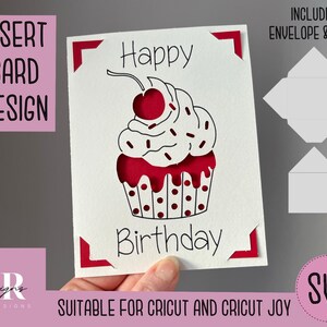 May include: A white card with a red cupcake design and the text "Happy Birthday". The card has red corners and includes a matching envelope and liner. The card is suitable for Cricut and Cricut Joy.