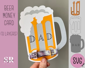 May include: A three-layer paper craft beer money card with a beer mug design. The card has a slot for a bill and the word "DAD" is cut out of the mug. The card is designed to be assembled and used as a gift.