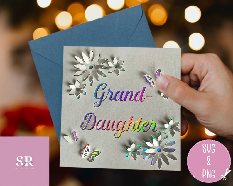 May include: A white card with the words "Grand-Daughter" in rainbow colors. The card has a cut-out design of flowers and butterflies.
