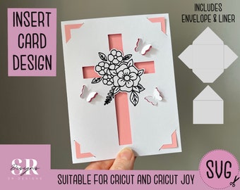 May include: A white card with a pink cross and floral design. The card has a cut-out design for an insert card. The card includes an envelope and liner. The card is suitable for Cricut and Cricut Joy.