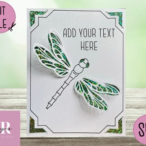 May include: A white card with a black frame and a green dragonfly cut out. The card has the text "ADD YOUR TEXT HERE" in black.