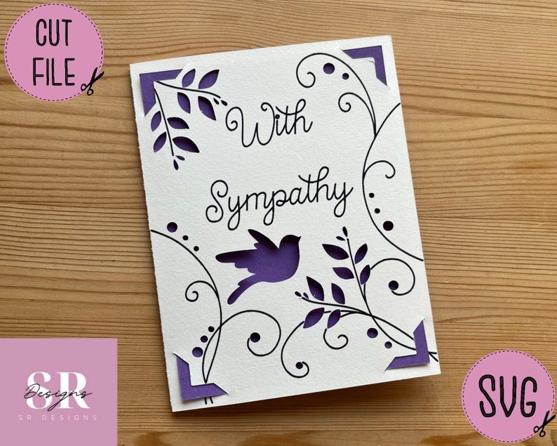 May include: A white card with a purple border and a black design of a bird and vines. The text "With Sympathy" is written in black cursive.