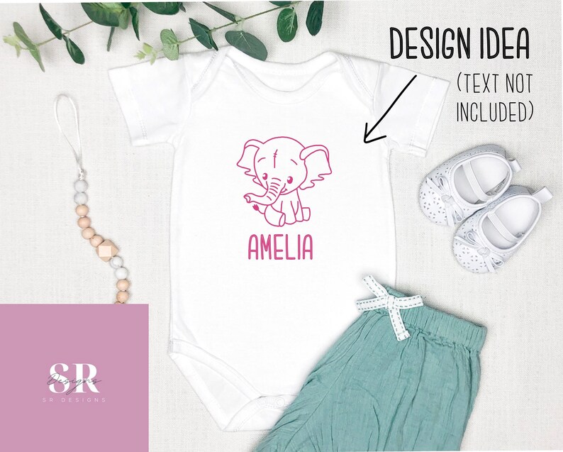 May include: White baby onesie with a pink outline of an elephant and the name Amelia printed below. The onesie is on a white background with a wooden bead necklace and a pair of white baby shoes.