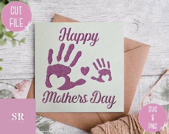May include: A white card with the text "Happy Mothers Day" in a pink glittery font. Two pink glittery handprints are on the card, one large and one small, with a small pink heart between them.