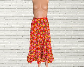 May include: A red maxi skirt with a floral print featuring pink and yellow flowers. The skirt has a ruffled hem.