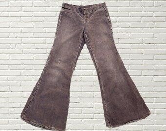 May include: A pair of brown wide-leg jeans with a button fly.