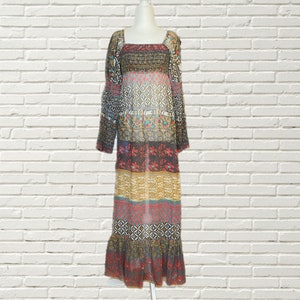 May include: A long, flowing maxi dress with a colorful, patterned design. The dress has a square neckline and long sleeves. The fabric is sheer and lightweight, making it perfect for warm weather.