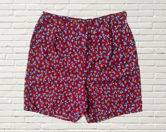 May include: Red shorts with a small blue and green floral pattern.