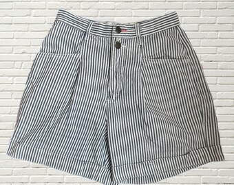 May include: White and black striped high-waisted shorts with a button and zipper closure.