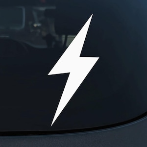 May include: White lightning bolt decal sticker for a car or truck. The sticker is on a dark blue background.