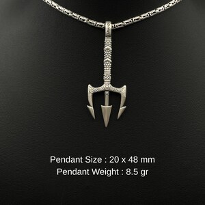 May include: A silver trident pendant with a decorative handle and a chain necklace. The pendant measures 20 x 48 mm and weighs 8.5 grams. The necklace is displayed against a black background.