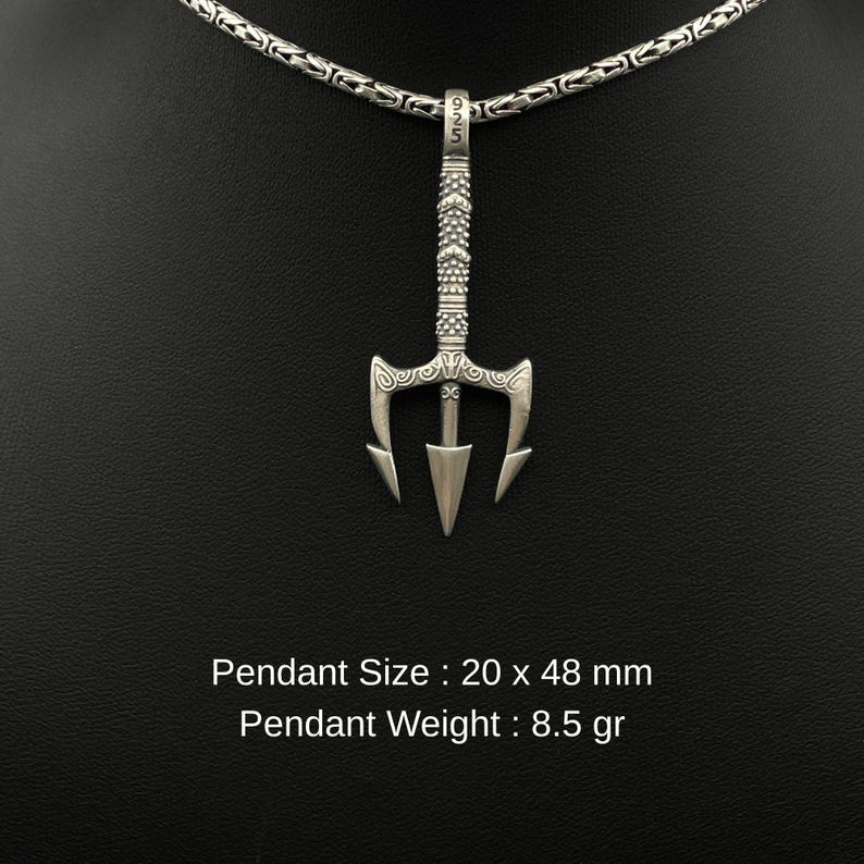 May include: A silver trident pendant with a decorative handle and a chain necklace. The pendant measures 20 x 48 mm and weighs 8.5 grams. The necklace is displayed against a black background.