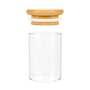 May include: A clear glass jar with a bamboo lid. The lid has a white silicone seal.