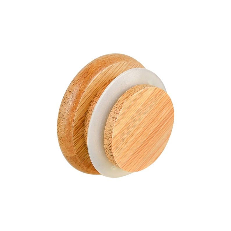 May include: A round wooden lid with a silicone seal. The lid is made of light brown wood and has a natural grain pattern. The silicone seal is clear and helps to create a tight seal.
