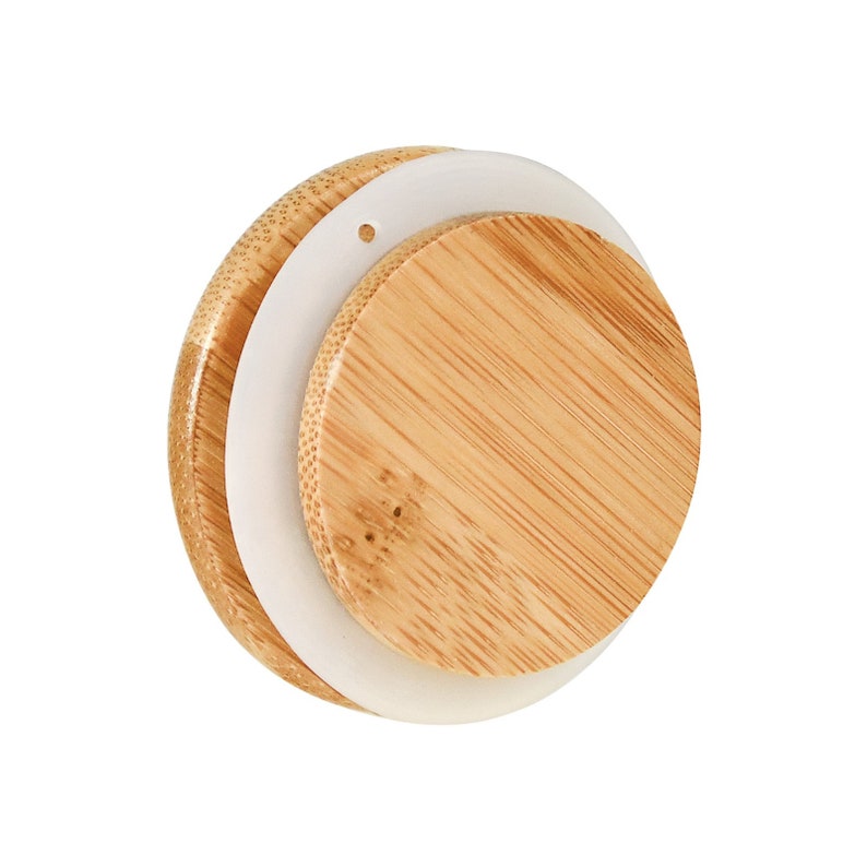 May include: A round, wooden lid with a white silicone seal. The lid has a small hole in the center.