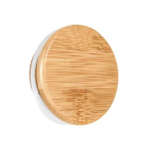 May include: A round, wooden lid with a white rim. The lid is made of natural bamboo and has a smooth, polished finish.