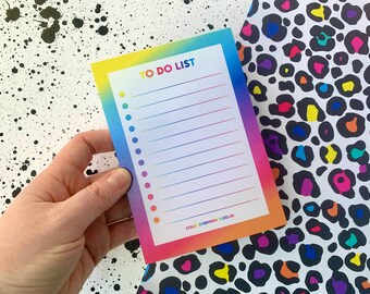 May include: A rectangular to-do list notepad featuring a vibrant rainbow gradient border, white center, and horizontal lines with circular bullet points. The text TO DO LIST is printed at the top, and COLORPOPPRINTS.CO.UK is at the bottom.